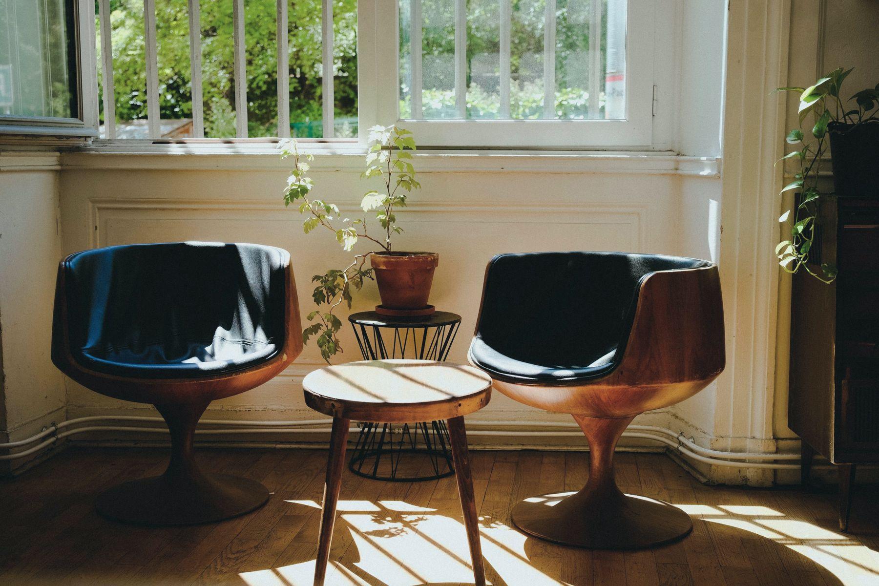 Two chairs and a small table in a sunlit room